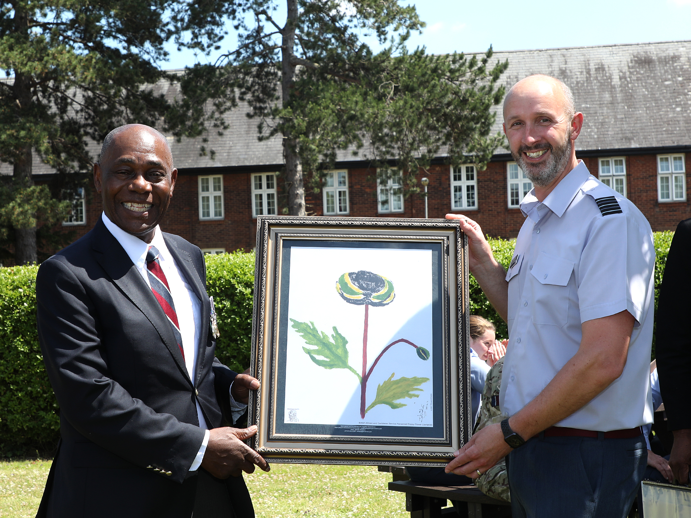 Mr Donald Campbell presents a picture of the Caribbean poppy to Wing Commander Jez Case